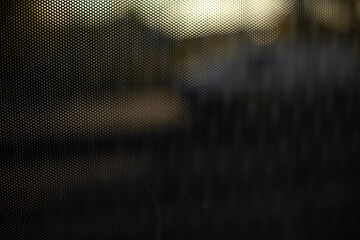Glass on a bus. Cloudy texture. Blurred background. Dark glass.