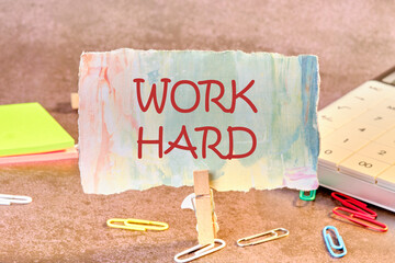 Work Hard written on paper in a clothespin