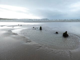 The remains of the unknown shipwreck become visible during the storm at Dooey beach by...