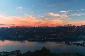 The lights and colors of the sunset on Lake Como, near the town of Tremezzo, Italy - December 24, 2023 - obrazy, fototapety, plakaty