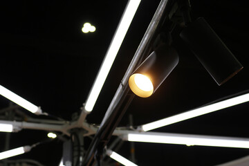 Black track light modern style installed on ceiling structure with dark background.