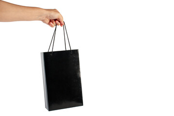 Hand Holding black paper bag isolated on transparent background.