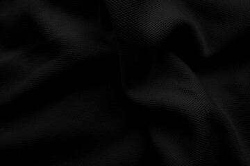 Black cloth blackground. Dark wavy fabtic.