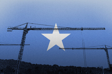 Somalia flag with big cranes, construction industry concept, growth and development in construction 