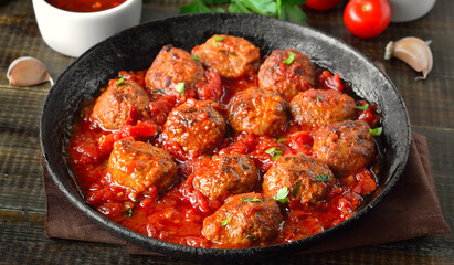 Meatballs with parsley in frying pan