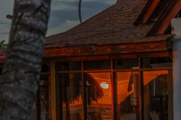 Reflection of a stunning sunrise in the window of a restaurant on the beach in Punta Cana
