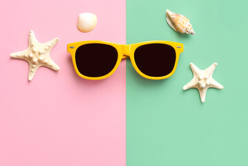 Top view of yellow sunglasses, starfish and seashells with copy space for text. Summer vacation...