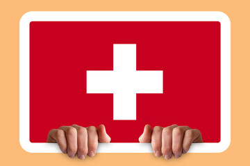 Obraz premium Hands holding a white frame with Switzerland flag, celebration or campaigning concept, two hands 