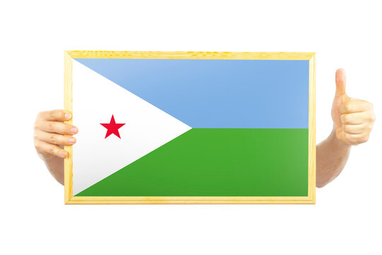 Hands holding a frame with Djibouti flag, independence day idea, approvement or success in 