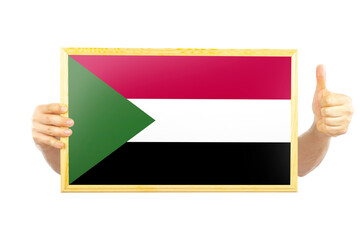 Hands holding a frame with Sudan flag, independence day idea, celebration or victory concept, two 