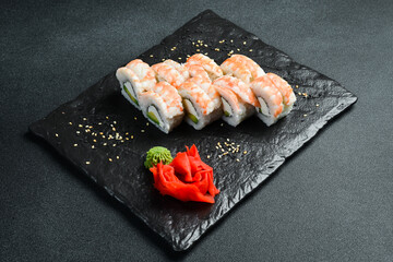 Traditional fresh Japanese sushi rolls with shrimp. Served with wasabi sauce and pickled ginger. Close up.