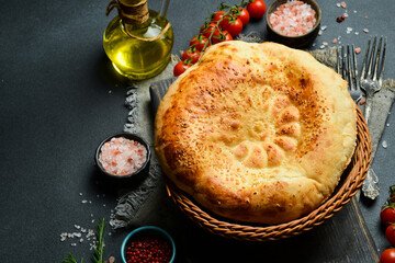 Pita bread on dark background. Arabic, Lebanese bread, traditional food. Close-up, dark background.