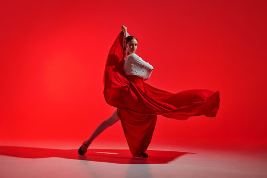 Beautiful woman, performing flamenco with grace, dynamic movements reflecting fiery heart of traditional Spanish dance. Concept of art of movement, classical dance, beauty, festival