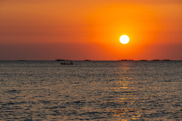 Sunset over the sea background. Big sun over the sea with beautiful natural light at sunset or sunrise.