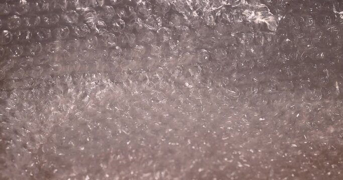 old air cellophane with a lot of bubbles for safe storage of things, close-up of a protective film with air bubbles