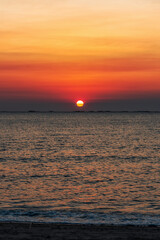 Sunset over the sea background. Big sun over the sea with beautiful natural light at sunset or sunrise.