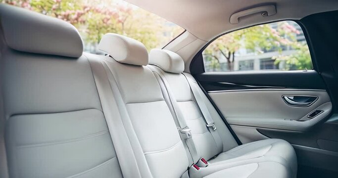 Luxurious rear white leather seats of a modern car. Bright car interior