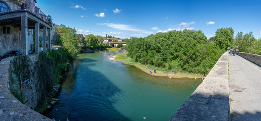 Sauve, France - 04 16 2024: Panoramic View of the Village and the river from the Old Bridge Gate.