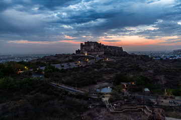 ancient historical fort with dramatic sunset sky at dusk from flat angle