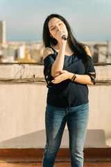 Girl vocalist doing a musical show on the rooftop