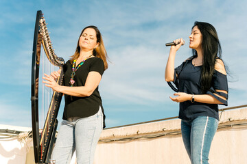 Harpist and vocalist doing a musical show on the roof