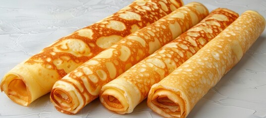 Top view of rolled pancakes on light surface with ample space for text placement