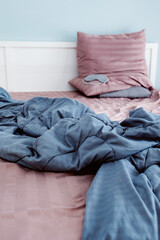 Unmade bed in modern bedroom