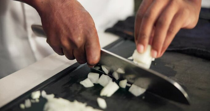Chef, hands and onions for cutting in kitchen, teaching and learn for professional skills. Restaurant, jubilee or vegetables chop for culinary student, ingredient and prepare with recipe cuisine