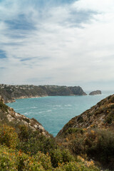 Panoramic view, cliffs and Mediterranean sea on a cloudy morning day, in Jávea, Alicante (Spain).