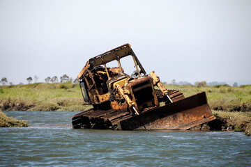 abandoned rusted bulldozer in Aveiro lagoon Ria de Aveiro located on the Atlantic coast of Portugal
