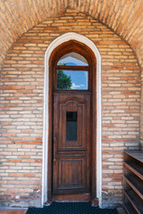 ancient carved wooden door to student room in islamic Kukeldash madrasah with a traditional pattern in Uzbekistan in Tashkent