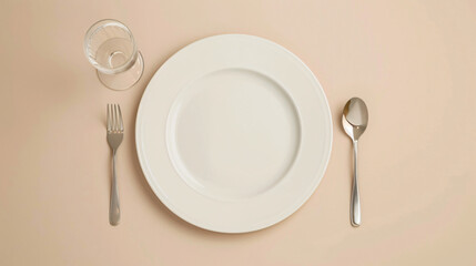 Clean plate fork and glass on beige background 