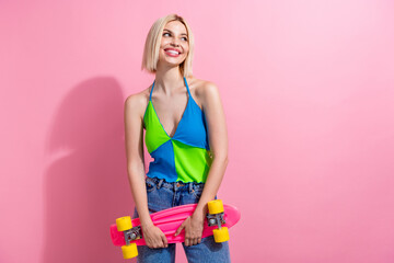 Portrait of friendly woman with bob hair wear colorful top hold skateboard look at promo empty...