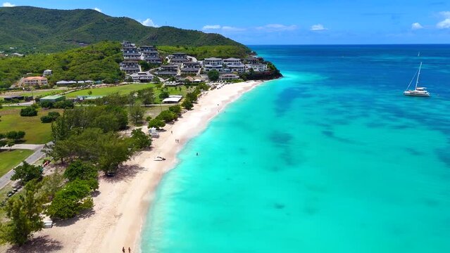 Aerial view of the beautiful Ffryes Beach at the Caribbean island of Antigua with turquoise sea and fine sand