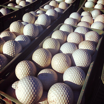 Tee Off in Style: Bins of Golf Balls at Driving Range