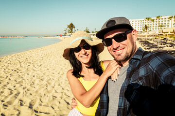 Happy multiracial couple taking selfie on summer vacation - Trendy man and woman having fun on...