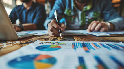 Deep focus on data analysis.In-depth Analysis and Collaborative Discussion Over Pie Charts and Bar Graphs in a Business Meeting.