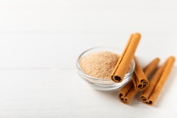 Cinnamon sugar on a texture background. Homemade cinnamon sugar in a bowl on background. Brown sugar. Spice mixture for drinks and baking. Place for text. Copy space.
