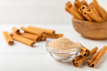 Cinnamon sugar on a texture background. Homemade cinnamon sugar in a bowl on background. Brown sugar. Spice mixture for drinks and baking. Place for text. Copy space.