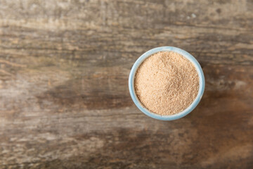 Cinnamon sugar on a texture background. Homemade cinnamon sugar in a bowl on background. Brown sugar. Spice mixture for drinks and baking. Place for text. Copy space.