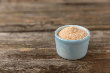 Cinnamon sugar on a texture background. Homemade cinnamon sugar in a bowl on background. Brown sugar. Spice mixture for drinks and baking. Place for text. Copy space.