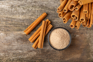 Cinnamon sugar on a texture background. Homemade cinnamon sugar in a bowl on background. Brown sugar. Spice mixture for drinks and baking. Place for text. Copy space.