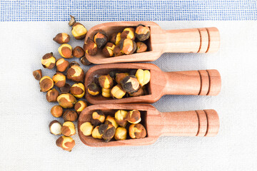 Healthy and tasty roasted black chana background, close-up of roasted and salted black chickpeas,...