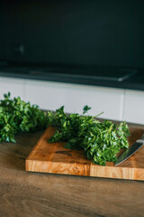 Chopped Fresh Herbs on a Bamboo Cutting Board: A pile of chopped mint, cilantro, and parsley on a...