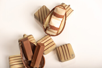 Chocolate eggs, small chocolate eggs details, white background, selective focus.