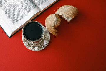 Bread and wine, communion concept on red background, top view