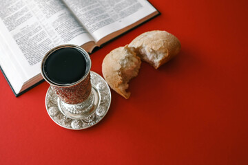Bread and wine, communion concept on red background, top view