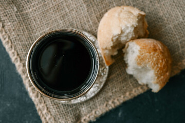 Bread and wine, communion concept on red background, top view