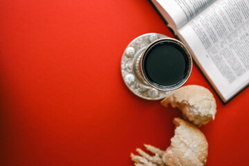 Bread and wine, communion concept on red background, top view
