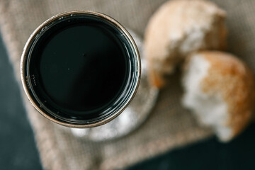 Bread and wine, communion concept on red background, top view